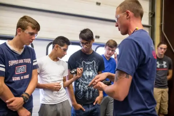Astro employee in the process of explaining something to students